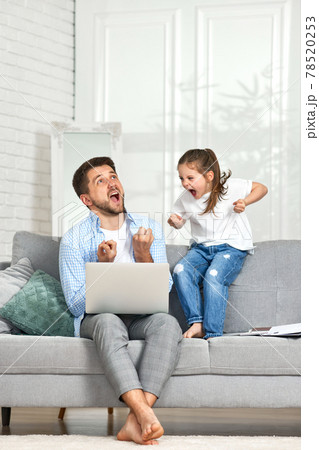 child and father yell at each other because the daughter is interfering with the father's work child and father yell at each other because the daughter is interfering with the father's work 78520253
