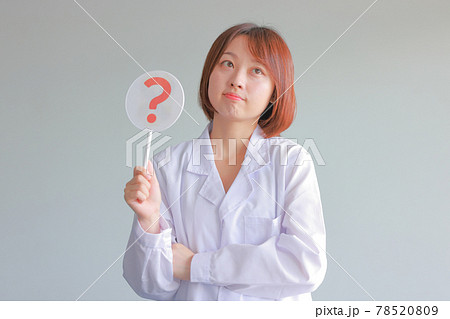 はてなのプレートを持ち上を見て考える白衣の女性 はてなのプレートを持ち上を見て考える白衣の女性 78520809