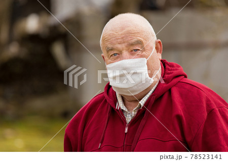 Portrait of an elderly European man with a short haircut in a protective safe medical mask, close-up Portrait of an elderly European man with a short haircut in a protective safe medical mask, close-up 78523141