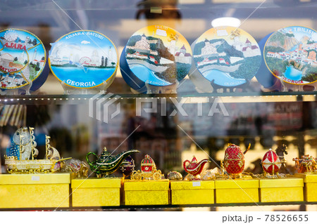 Colorful ceramic plates on showcase of Georgian gift shop 78526655