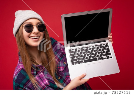 Close-up portrait of Beautiful smiling happy funny pretty charming young woman holding netbook 78527515