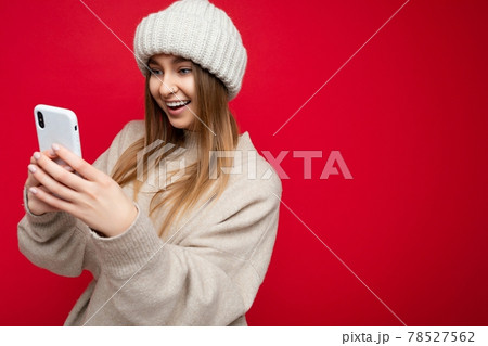 Photo shot of attractive happy smiling positive good looking young woman wearing casual stylish Photo shot of attractive happy smiling positive good looking young woman wearing casual stylish 78527562