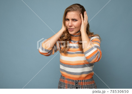 Photo of emotional dissatisfied young attractive blonde curly woman with sincere emotions wearing 78530650
