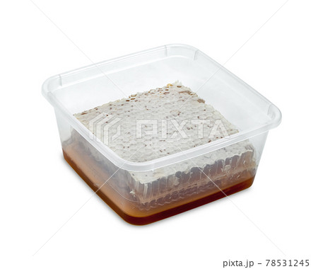 Fresh Honeycomb slice and honey in plastic box isolated on white background Fresh Honeycomb slice and honey in plastic box isolated on white background 78531245