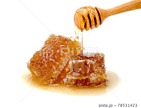 Fresh Honeycomb slice and wooden honey dipper isolated on white background 78531423