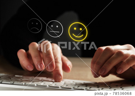 Good mood concept made of emoticon and rating. The girl puts an assessment using the keyboard. Good mood concept made of emoticon and rating. The girl puts an assessment using the keyboard. 78536068