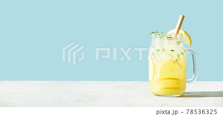 Banner. Lemonade on blue background close up, copy space Banner. Lemonade on blue background close up, copy space 78536325