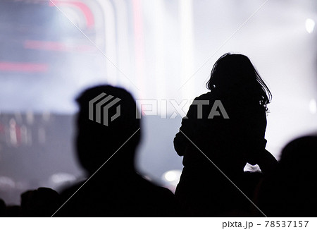Rear view of crowd with arms outstretched at concert 78537157