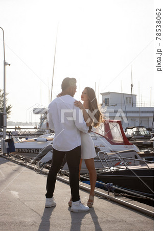 Couple standing in port in summer 78538062