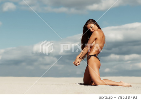 Sexual woman in bikini panties on beach 78538793