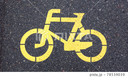 Bicycle symbol representing a path for bicycles. Yellow painted sign for bicycles on the asphalt. Flat lay, top view. Bicycle symbol representing a path for bicycles. Yellow painted sign for bicycles on the asphalt. Flat lay, top view. 78539039
