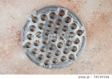 Old aluminum dumplings mold on concrete background. Old aluminum dumplings mold on concrete background. 78540588