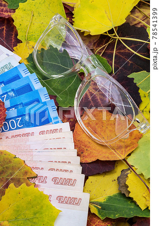 Money on autumn leaves. Russian money and glasses. Autumn still life. Money on autumn leaves. Russian money and glasses. Autumn still life. 78541399