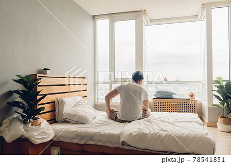 Lonely and depressed man in his bedroom in the apartment. Lonely and depressed man in his bedroom in the apartment. 78541851