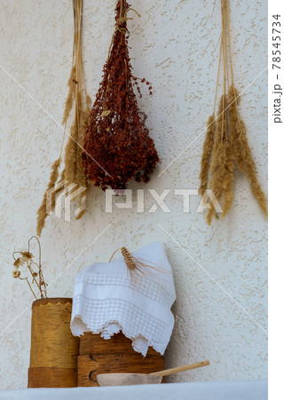 Medicinal herbs and birch bark boxes against a white wall 78545734