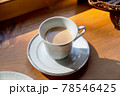 山小屋のカウンターで、ティーカップに淹れられた一杯のロイヤルミルクティー。 78546425