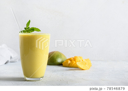Indian mango or turmeric lassi on gray background Indian mango or turmeric lassi on gray background 78546879