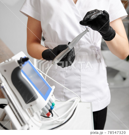 Dentist doctor hands holding dentist tools in dental clinic Dentist doctor hands holding dentist tools in dental clinic 78547320
