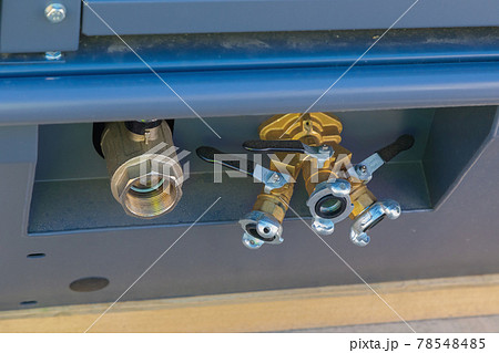Outlet ball valves on an air compressor close-up Outlet ball valves on an air compressor close-up 78548485