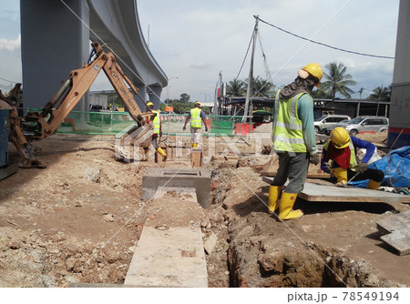 SEREMBAN, MALAYSIA -FEBRUARY 24, 2017: Underground utility and services pipe lay by workers at the construction site. SEREMBAN, MALAYSIA -FEBRUARY 24, 2017: Underground utility and services pipe lay by workers at the construction site. 78549194