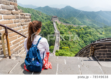 Great Wall of china. Tourist on Asia travel looking at Chinese landscape sitting relaxing on famous Chinese tourist destination and attraction in Badaling north of Beijing. Woman traveler on vacation 78549638
