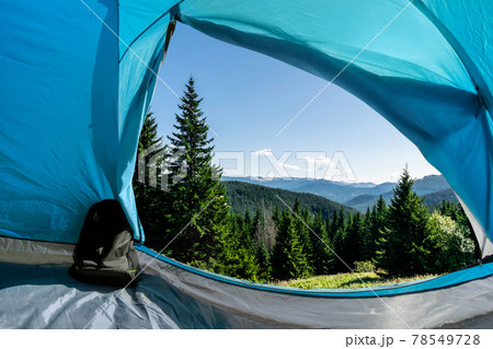 Mountain forest view from a camping tent. Mountain forest view from a camping tent. 78549728