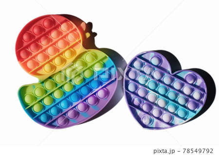 children pop it toys isolated, duck and heart shaped fidgets rainbow colored. multicolor silicone bubbles toys for relax and antistress. tik tok trend. 78549792