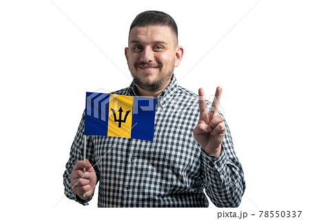 White guy holding a flag of Barbados and shows two fingers isolated on a white background 78550337