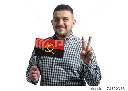 White guy holding a flag of Angola and shows two fingers isolated on a white background White guy holding a flag of Angola and shows two fingers isolated on a white background 78550338