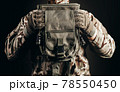 Soldier in gloves holding tactical leg bag. 78550450