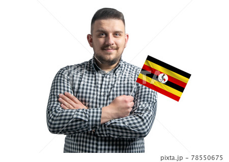 White guy holding a flag of Uganda smiling confident with crossed arms isolated on a white background White guy holding a flag of Uganda smiling confident with crossed arms isolated on a white background 78550675