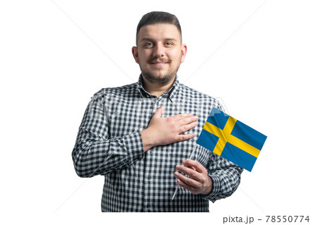 White guy holding a flag of Sweden and holds his hand on his heart isolated on a white background With love to Sweden White guy holding a flag of Sweden and holds his hand on his heart isolated on a white background With love to Sweden 78550774