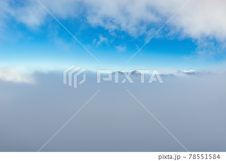 Clouds above the mountain tops at day time. 78551584