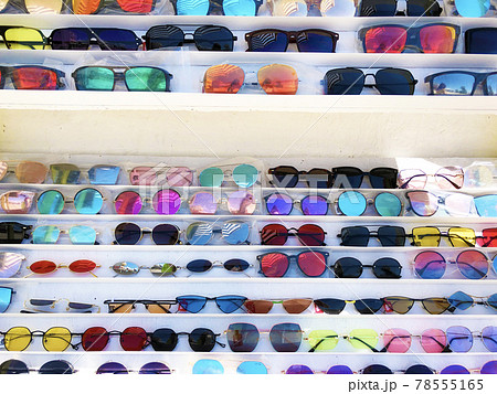 A lot of different colourful sunglasses range at store A lot of different colourful sunglasses range at store 78555165