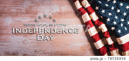 4th of July happy independence day concept. Vintage American flag with the text on old wooden background. 4th of July happy independence day concept. Vintage American flag with the text on old wooden background. 78556956