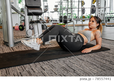 Asian sports woman in the gym, athletes training, workout lifting weight, plank and push up. tattoo Asian sports woman in the gym, athletes training, workout lifting weight, plank and push up. tattoo 78557441