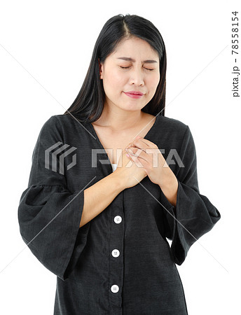 Portrait of young woman holding her chest and having a heart attack on white background. Healthcare Concept. 78558154