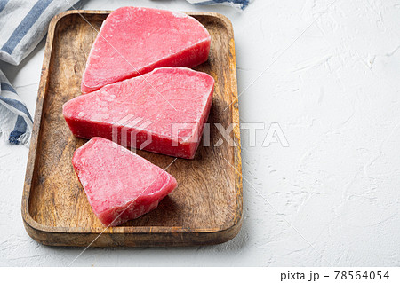 Frozen tuna fish steaks, on wooden tray, on white stone background , with copyspace and space for text Frozen tuna fish steaks, on wooden tray, on white stone background , with copyspace and space for text 78564054