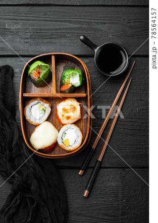 Homemade Sushi Bento Box with Sushi Rolls, on black wooden table background, top view flat lay Homemade Sushi Bento Box with Sushi Rolls, on black wooden table background, top view flat lay 78564157