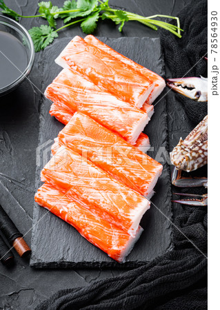 Fresh Crab meat surimi with blue swimming crab, on stone board, on black background Fresh Crab meat surimi with blue swimming crab, on stone board, on black background 78564930