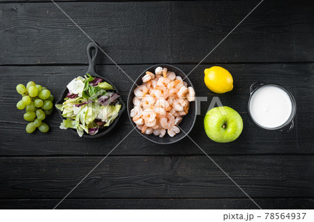 Waldorf prawn salad ingredients , with sauce apple and grape, on black wooden table , top view flat lay, with copy space for text 78564937