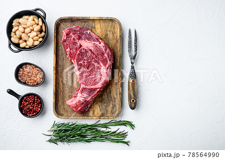 Raw fresh meat Ribeye steak entrecote of Black Angus Prime meat with ingredients, on white stone background, top view flat lay, with copy space for text Raw fresh meat Ribeye steak entrecote of Black Angus Prime meat with ingredients, on white stone background, top view flat lay, with copy space for text 78564990