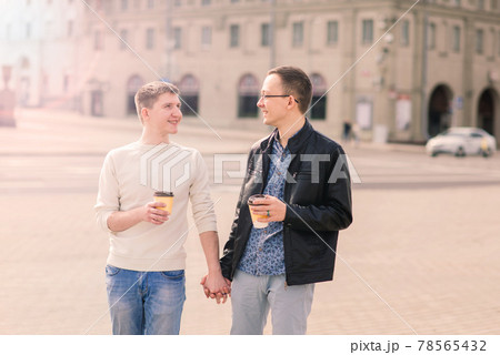Young gay couple smiling happy and hugging at the city. Young gay couple smiling happy and hugging at the city. 78565432