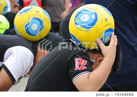 SELANGOR, MALAYSIA -SEPTEMBER 6, 2015: Children undergoing football training. Just wear casual clothing rather than sportswear. SELANGOR, MALAYSIA -SEPTEMBER 6, 2015: Children undergoing football training. Just wear casual clothing rather than sportswear. 78568888