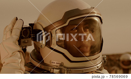Female astronaut shooting terrain of Mars 78569069