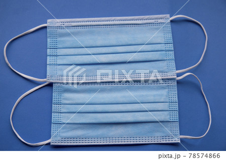 antibacterial medical mask of blue color on a blue background virus epidemic coronavirus protection antibacterial medical mask of blue color on a blue background virus epidemic coronavirus protection 78574866
