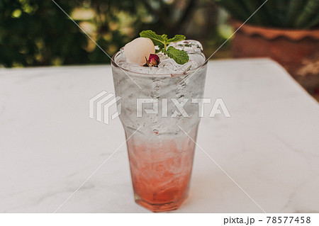 Lychee Pink Rose Italian Soda in glass decorated with Mint leaves. 78577458