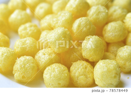 Yellow round corn snacks with cheese flavor Yellow round corn snacks with cheese flavor 78578449