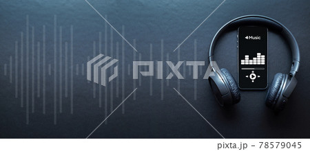 Music banner. Mobile smartphone screen with music application, sound headphones. Audio voice with radio beats on black background. Broadcast media music banner with copy space. 78579045