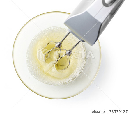 beating egg whites cream with mixer in the bowl 78579127